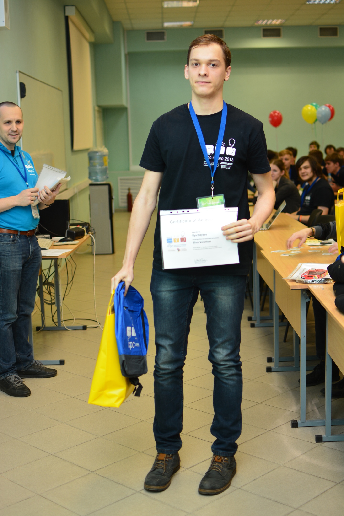 Ilya holding a silver volunteer certificate at ICPC NEERC 2018